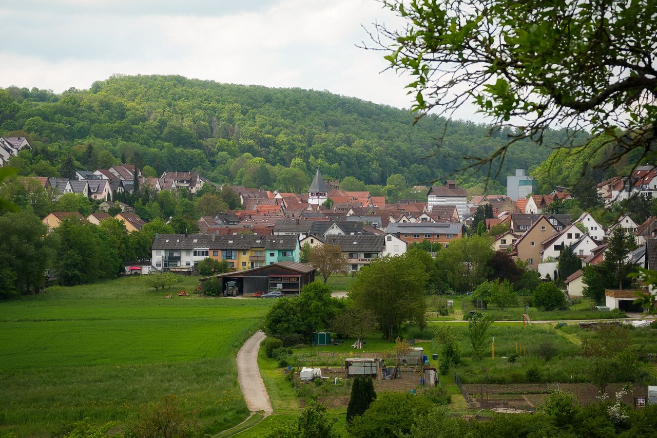 A picturesque view of Mönsheim, BW, Germany, with lush greenery and quaint houses.