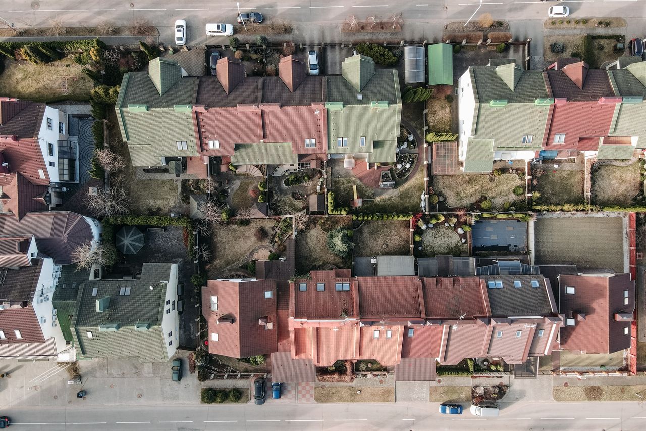 High-angle view of a suburban residential area with colorful rooftops and gardens.